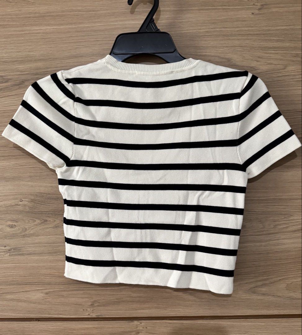 Zara Striped Cropped T-Shirt (Category: Shirts) located in San Juan City. Submitted by a.t_closet (Listing ID 1451411367, Image 2). Description: - Classic black and white striped cropped t-shirt from Zara. - Features a comfortable ribbed texture. - Short sleeves and a crew neck design. - Versatile for casual wear, easily paired with jeans or skirts. - Great for wearing alone or as a layering piece..