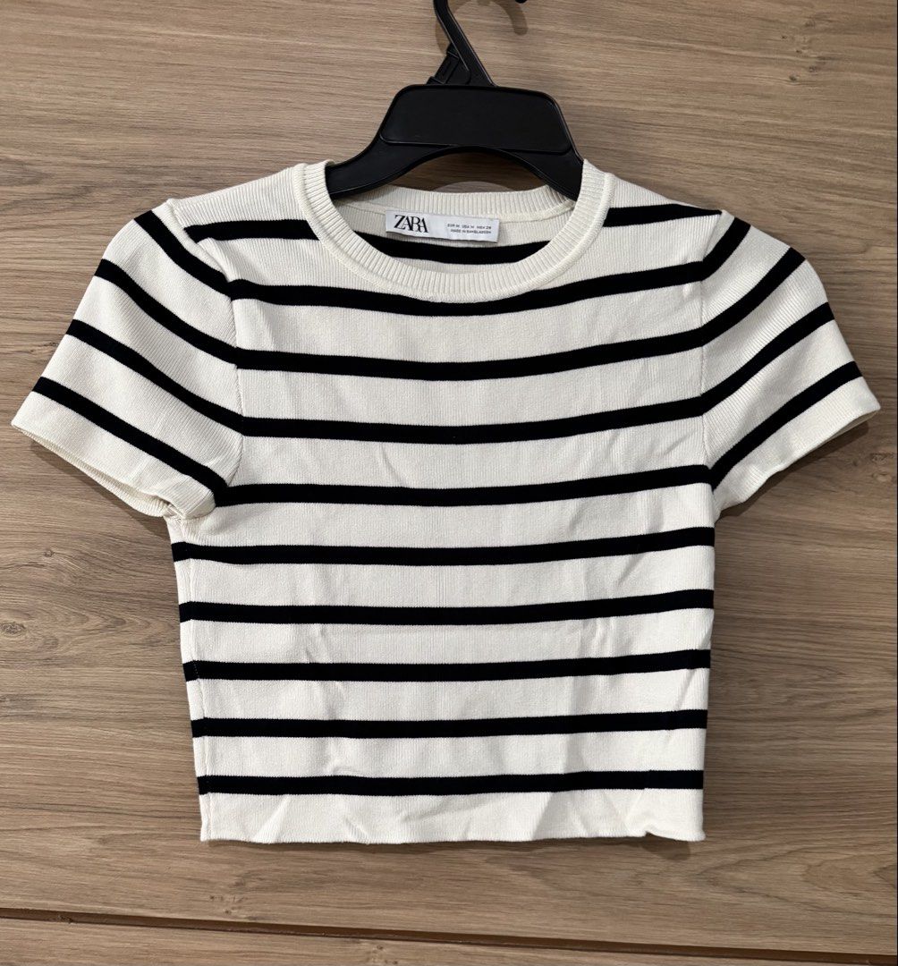 Zara Striped Cropped T-Shirt (Category: Shirts) located in San Juan City. Submitted by a.t_closet (Listing ID 1451411367, Image 1). Description: - Classic black and white striped cropped t-shirt from Zara. - Features a comfortable ribbed texture. - Short sleeves and a crew neck design. - Versatile for casual wear, easily paired with jeans or skirts. - Great for wearing alone or as a layering piece..