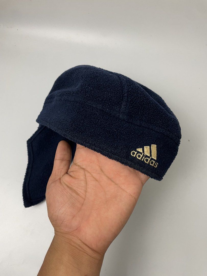 Adidas Fleece Hat with Ear Flaps - Navy Blue (Category: Caps & Hats) located in Manila. Submitted by rdtp2 (Listing ID 1451527044, Image 2). Description: - Navy blue Adidas fleece hat - Features ear flaps for extra warmth - Gold embroidered Adidas logo - Made from soft fleece material - Ideal for cold weather - Keeps head and ears cozy and protected.