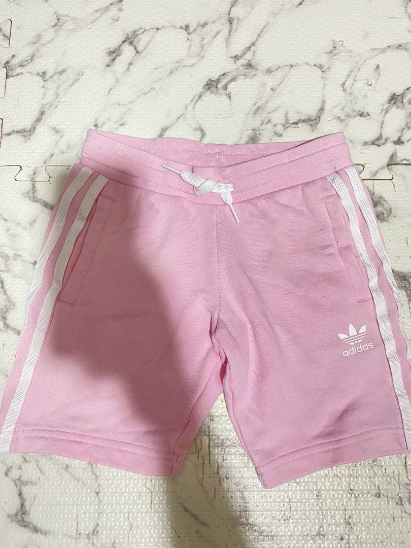 Adidas Pink Shorts with White Stripes (Category: Babies & Kids Fashion) located in Valenzuela. Submitted by acandychin (Listing ID 1451697972, Image 1). Description: - Pink Adidas shorts for kids - Classic white stripes on the sides - Drawstring waist for a comfortable fit - Adidas logo on the leg - Made from a soft cotton blend - Ideal for playtime and lounging 4-5y.