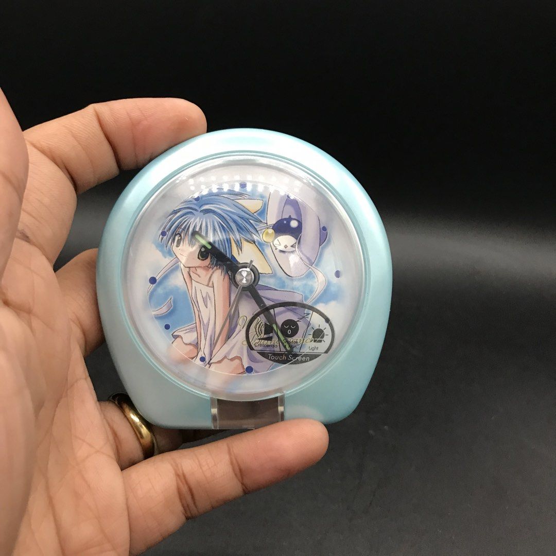 Anime Character Light Blue Alarm Clock (Category: Clocks) located in Baao. Submitted by all.things.japan (Listing ID 1451606209, Image 2). Description: - 3.0 inches diameter. - Cute light blue alarm clock with anime character design - Includes alarm and time setting capabilities - Battery operated - Minor scuffs on casing - Ideal for collectors or as a fun bedside accessory.