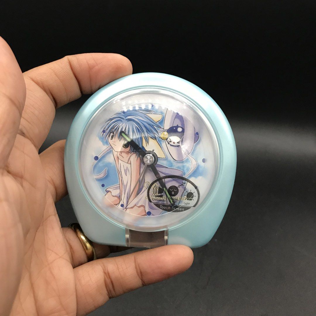 Anime Character Light Blue Alarm Clock (Category: Clocks) located in Baao. Submitted by all.things.japan (Listing ID 1451606209, Image 3). Description: - 3.0 inches diameter. - Cute light blue alarm clock with anime character design - Includes alarm and time setting capabilities - Battery operated - Minor scuffs on casing - Ideal for collectors or as a fun bedside accessory.