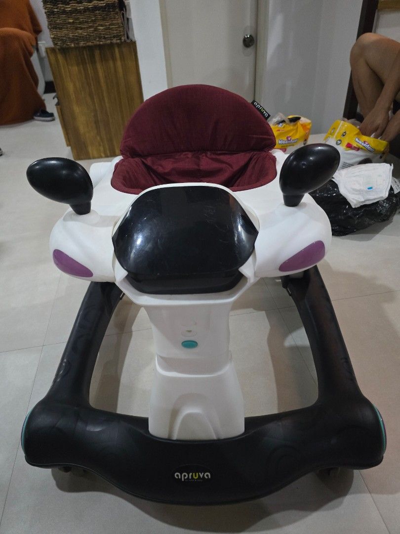 Apruva Baby Walker with Seat (Category: Other Kids Furniture) located in Muntinlupa City. Submitted by declutteringmoomah (Listing ID 1451623577, Image 1). Description: - Apruva Baby Walker - Comfortable padded seat - Sturdy frame with wheels for easy movement - Playful and engaging design - Aids in learning to walk - Minor scuffs from normal use.