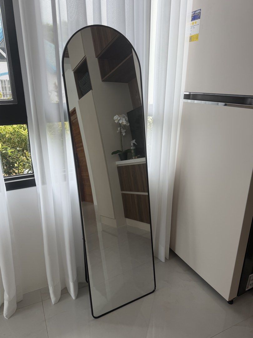 Arched Full Length Mirror with Black Frame (Category: Mirrors) located in Manila. Submitted by lovedbykeiz (Listing ID 1451563910, Image 1). Description: - Tall arched mirror with a sleek black frame. - Freestanding design with a sturdy base. - Ideal for checking outfits before going out. - Adds a modern touch to bedrooms, dressing rooms, or entryways. - Easy to move around your space..