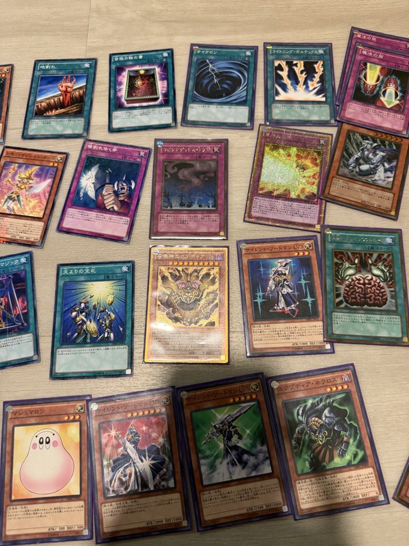 Assorted characters (Category: Raw Cards) located in Singapore. Submitted by ploopploop5 (Listing ID 1451643721, Image 1). Description: Large collection of Japanese Yu-Gi-Oh cards featuring various iconic monsters, spells, and traps. This bulk lot includes several holographic cards and classic staples from different sets. Great variety for fans of the original series and beyond. Can be sold individually .