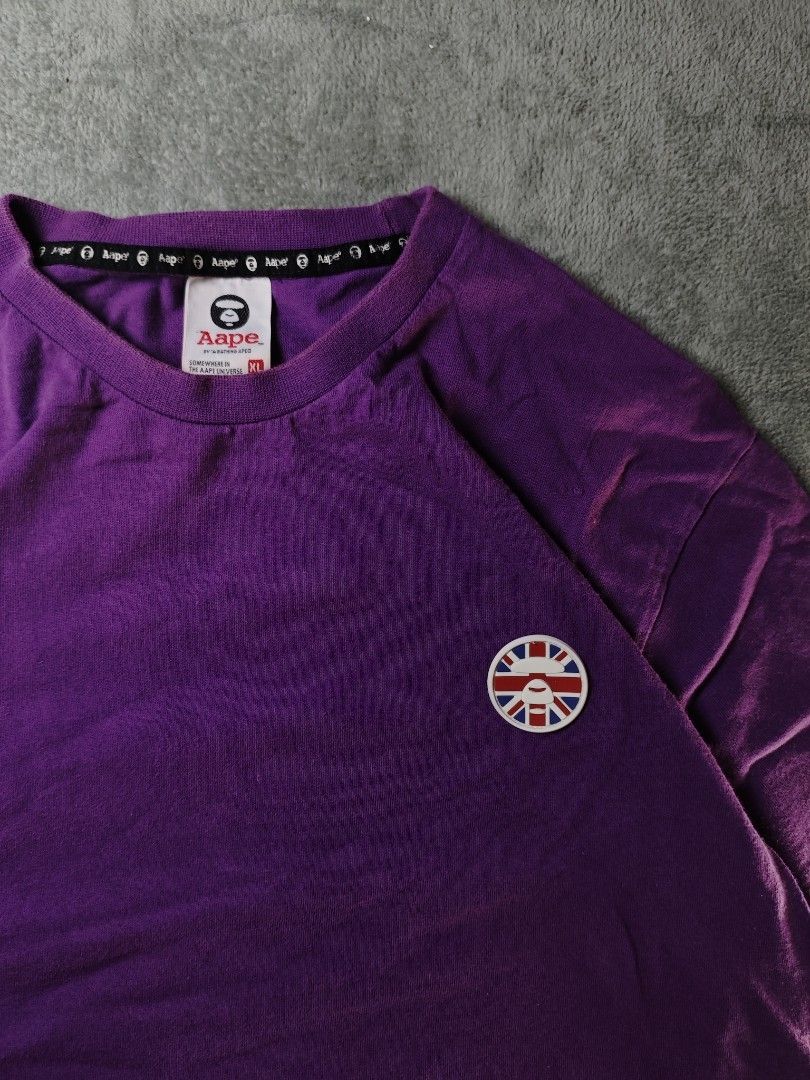 Authentic Aape Union Jack Rubberized Patch Purple Tee (Authentic/Legit) (Category: Tshirts & Polo Shirts ) located in San Pedro. Submitted by chronothrift (Listing ID 1451546828, Image 2). Description: - Size: XL (W22" x 29.5"L) - Condition: 9/10 - Color Rate: 9/10 - Flaws: Scratch, Minimal Discoloration Neck MOD: J&T Express / Lalamove / Meet MOP: Gcash / Bank Transfer.
