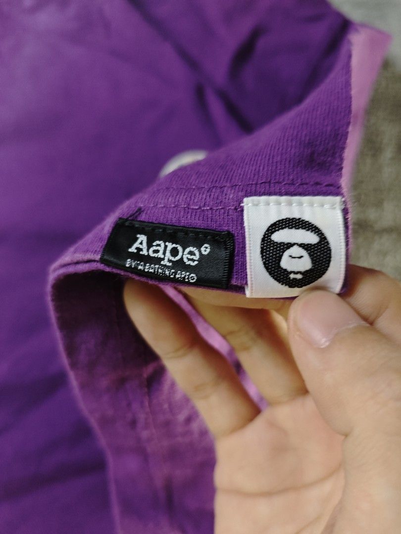 Authentic Aape Union Jack Rubberized Patch Purple Tee (Authentic/Legit) (Category: Tshirts & Polo Shirts ) located in San Pedro. Submitted by chronothrift (Listing ID 1451546828, Image 3). Description: - Size: XL (W22" x 29.5"L) - Condition: 9/10 - Color Rate: 9/10 - Flaws: Scratch, Minimal Discoloration Neck MOD: J&T Express / Lalamove / Meet MOP: Gcash / Bank Transfer.