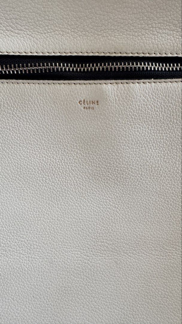 Authentic White Celine Edge Leather Tote Bag (Category: Luxury Bags & Wallets) located in Taguig. Submitted by annpo27 (Listing ID 1451694995, Image 2). Description: - Authentic Celine Edge tote in crisp white leather. - Secure zip closure on top. - Features multiple interior compartments for organization. - Interior shows minor signs of use (small marks). - Comes with dust bag. - An ideal and stylish everyday carry-all. - No damages, freshly con