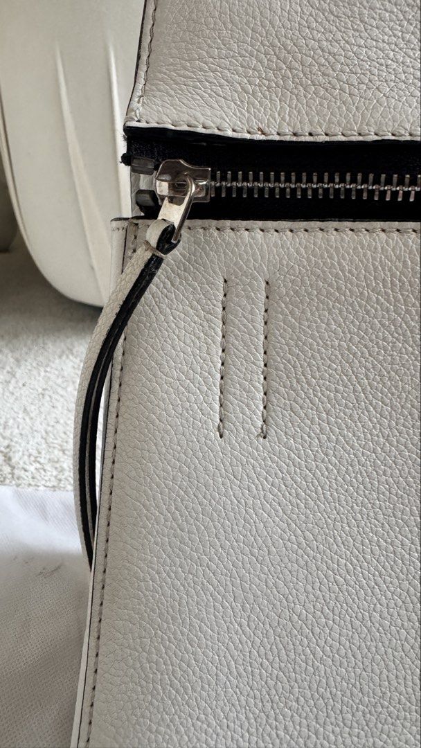 Authentic White Celine Edge Leather Tote Bag (Category: Luxury Bags & Wallets) located in Taguig. Submitted by annpo27 (Listing ID 1451694995, Image 3). Description: - Authentic Celine Edge tote in crisp white leather. - Secure zip closure on top. - Features multiple interior compartments for organization. - Interior shows minor signs of use (small marks). - Comes with dust bag. - An ideal and stylish everyday carry-all. - No damages, freshly con