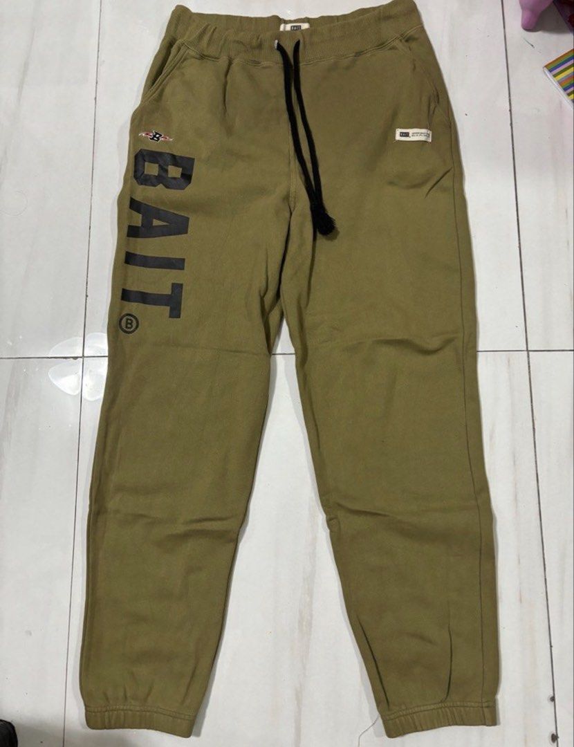 BAIT "BAIT" Logo Jogger Sweatpants Khaki Medium (Category: Joggers) located in Quezon City. Submitted by edether (Listing ID 1451640415, Image 1). Description: - Khaki jogger sweatpants from BAIT - Vertical 'BAIT' logo printed on the left leg - Small 'BAIT Superior Quality Goods' tag on the right hip - Elastic waistband with adjustable drawstring - Ribbed cuffs for a snug fit - Made from 100% Cotton - Proudly made in Taiwan Waist - 32-36in Length