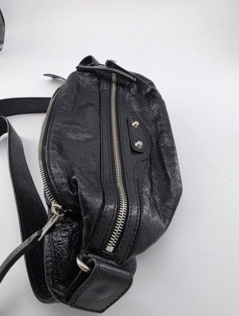 Balenciaga Black Leather Belt Bag (Category: Luxury Bags & Wallets) located in Quezon City. Submitted by deng43763 (Listing ID 1451650291, Image 2). Description: - Authentic Balenciaga black leather belt bag - Multiple zippered compartments for organization - Adjustable strap with buckle closure - Distinctive slightly crinkled leather texture - Silver-tone hardware - Comes with original dust bag.