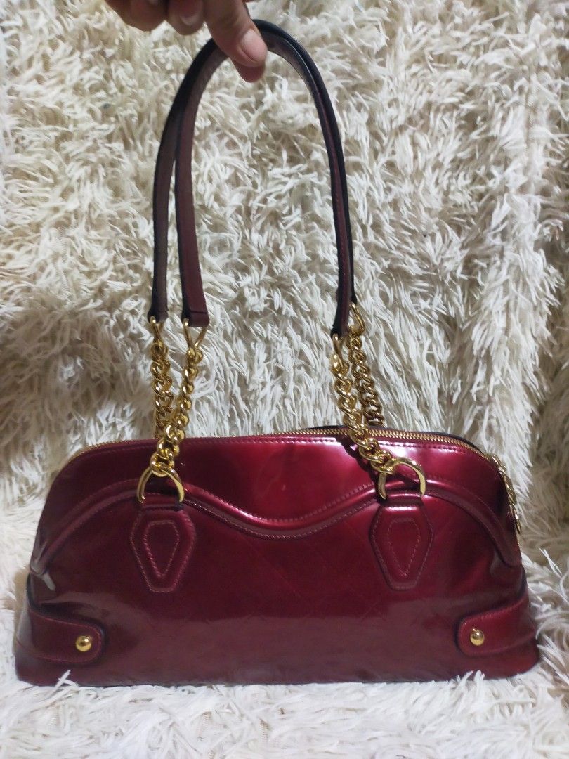 Balenciaga patent quilted (Category: Luxury Bags & Wallets) located in Manila. Submitted by darleng.d228ef (Listing ID 1451683545, Image 2). Description: This is a vintage Balenciaga patent quilted chain shoulder bag, identified by its glossy red finish and gold-tone chain strap. Brand: Balenciaga Material: Quilted patent leather (enamel) Key Features: Gold-tone chain shoulder strap and a front metal logo plate Era: Estimated to be from the mid-2