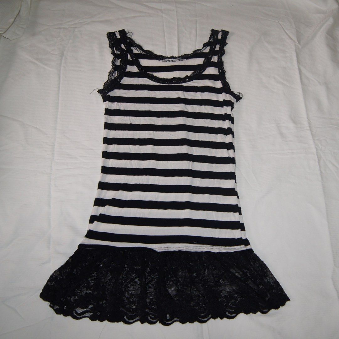 Black and White Striped With Lace Trim (Category: Dresses) located in Iloilo. Submitted by 080789 (Listing ID 1451675581, Image 1). Description: - Cute black and white striped mini dress - Features delicate lace trim along the neckline and straps - Black lace ruffle hem for a feminine touch - Versatile for layering or wearing on its own - Comfortable and stylish design.