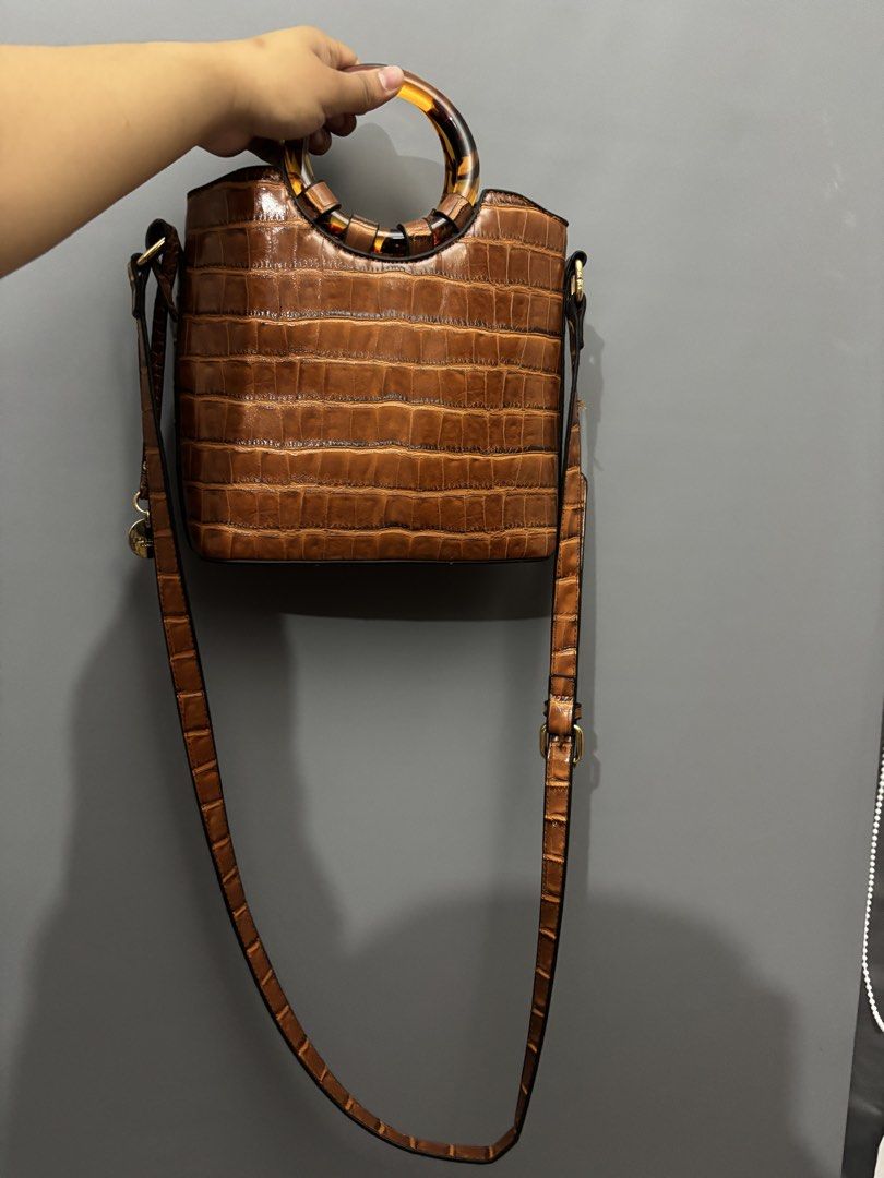 Brown Croc Embossed Top Handle Bag with Tortoiseshell Handle (Category: Luxury Bags & Wallets) located in Olongapo. Submitted by lovejeansph (Listing ID 1451559582, Image 1). Description: - Stylish brown bag with a sophisticated croc-embossed texture. - Features a unique tortoiseshell top handle. - Includes a long, adjustable strap for versatile crossbody or shoulder wear. - Accented with elegant gold hardware details on the side. - Ideal for bot