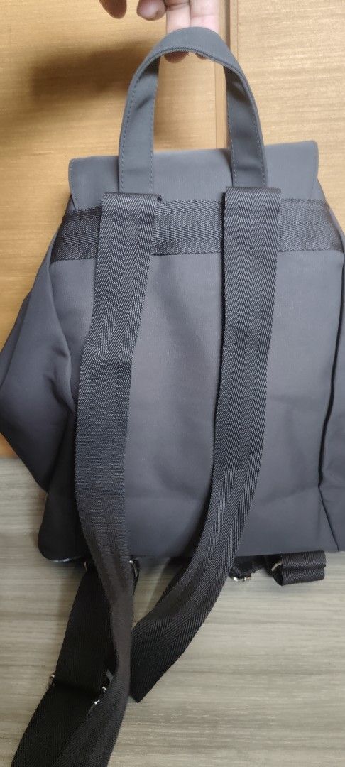 Burberry Nylon Backpack (Category: Luxury Bags & Wallets) located in San Mateo. Submitted by roxyj120919 (Listing ID 1451551300, Image 3). Description: - Classic Burberry backpack - Dark brown nylon material - Iconic Burberry check trim on front pockets and drawstrings - Spacious interior with flap closure - Adjustable shoulder straps for comfort - Ideal for everyday use or travel.