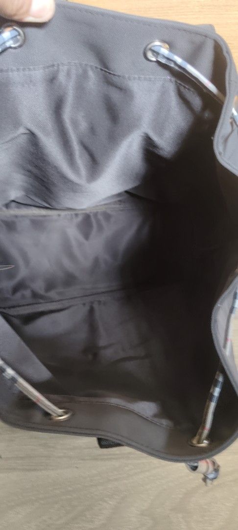Burberry Nylon Backpack (Category: Luxury Bags & Wallets) located in San Mateo. Submitted by roxyj120919 (Listing ID 1451551300, Image 2). Description: - Classic Burberry backpack - Dark brown nylon material - Iconic Burberry check trim on front pockets and drawstrings - Spacious interior with flap closure - Adjustable shoulder straps for comfort - Ideal for everyday use or travel.