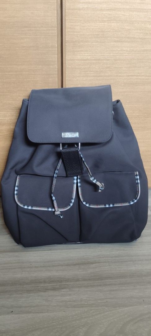 Burberry Nylon Backpack (Category: Luxury Bags & Wallets) located in San Mateo. Submitted by roxyj120919 (Listing ID 1451551300, Image 1). Description: - Classic Burberry backpack - Dark brown nylon material - Iconic Burberry check trim on front pockets and drawstrings - Spacious interior with flap closure - Adjustable shoulder straps for comfort - Ideal for everyday use or travel.