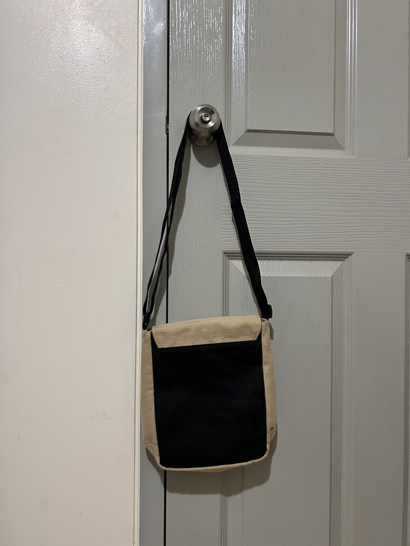Canvas Crossbody Bag with Black Strap (Category: Looking For) located in Manila. Submitted by declutteringmpc (Listing ID 1451688541, Image 2). Description: - Beige canvas crossbody bag - Black adjustable strap - Secure flap closure - Black panel on the back - Ideal size for everyday essentials - Easy and convenient to carry.