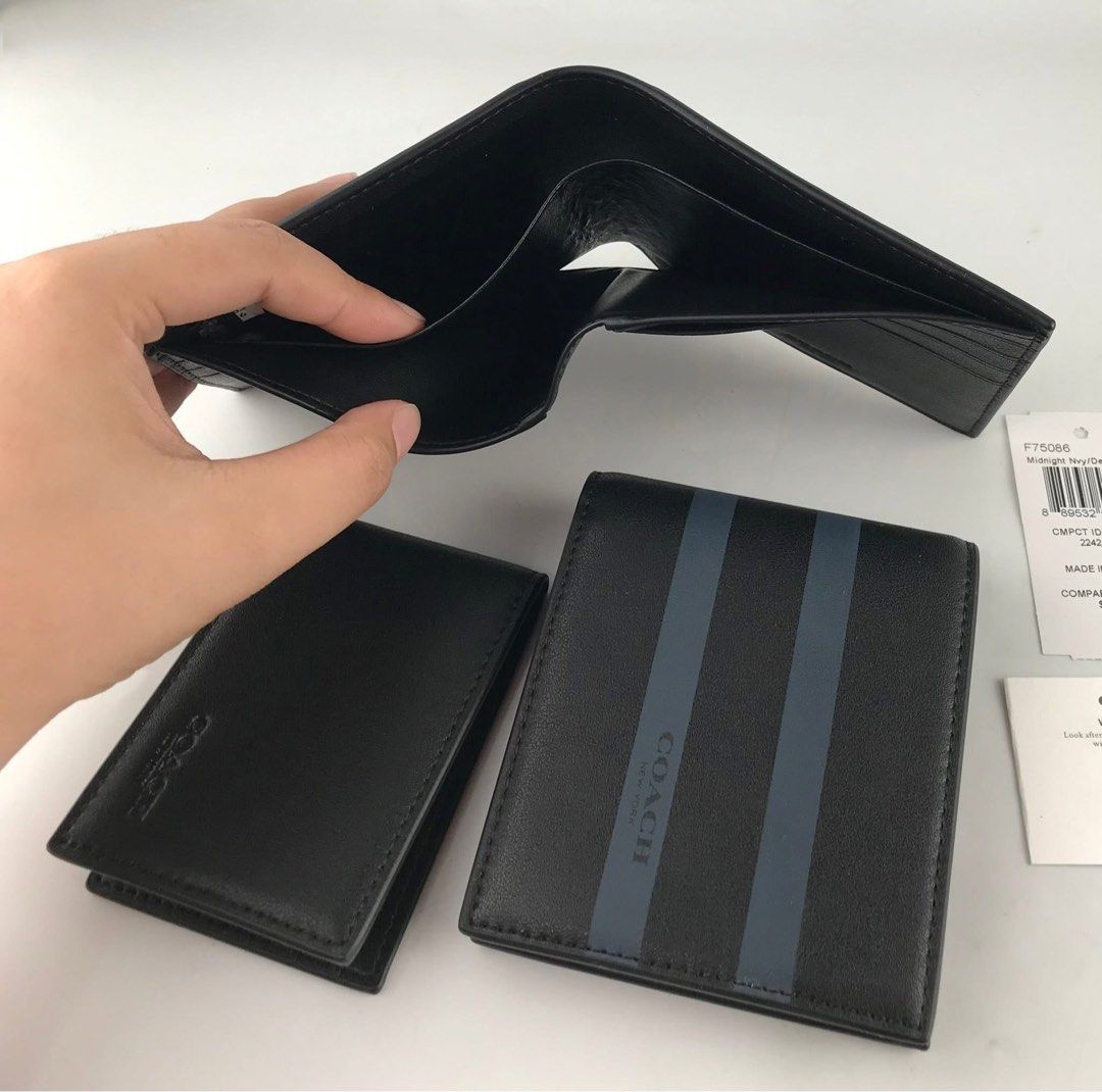 Coach Bifold Wallet with Stripes (Category: Wallets & Card Holders) located in Caloocan City. Submitted by brandeditemsph (Listing ID 1451527796, Image 3). Description: - Brand: Coach - Type: Bifold Wallet - Color: Black - Design: Dark blue stripes on front - Features: Multiple card slots - Condition: Brand new with original tags - Ideal for: Everyday use.