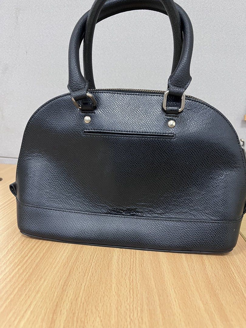 Coach Black Leather Dome Satchel Handbag (Category: Luxury Bags & Wallets) located in Pasig City. Submitted by zen_it_all (Listing ID 1451696733, Image 2). Description: - black leather Coach satchel - Classic dome shape with comfortable top handles - Replace zipper puller closure -zipper not so smooth when opening the bag -no hangtag, missing strap (you can use a generic one)) - Exterior back slip pocket for quick access - Protective metal feet o