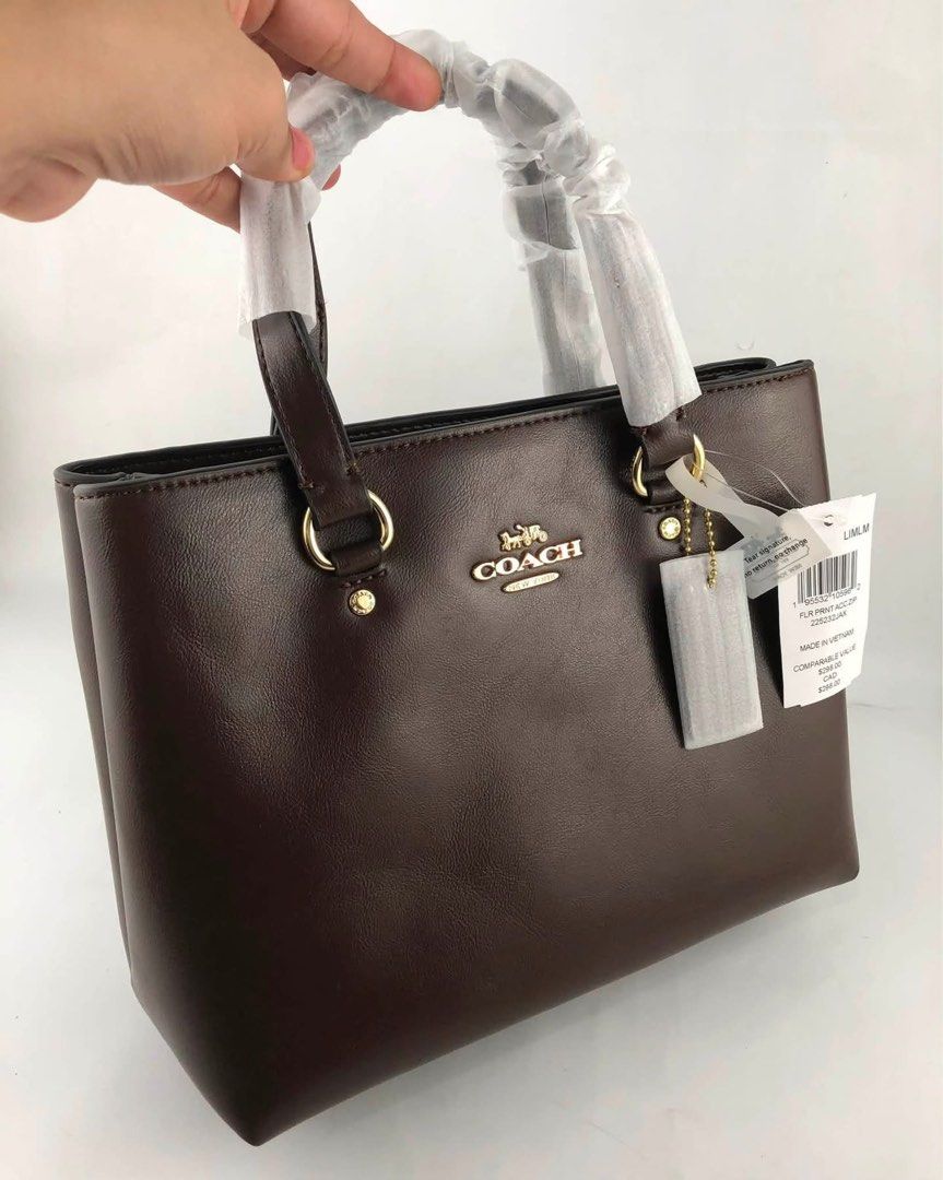 Coach Brown Leather Top Handle Bag (Category: Shoulder Bags) located in Caloocan City. Submitted by brandeditemsph (Listing ID 1451528273, Image 2). Description: - Genuine brown leather Coach bag - Versatile: Top handles and detachable crossbody strap - Elegant gold hardware details - Practical interior zip pocket - Comes with original tags - Proudly made in Vietnam.