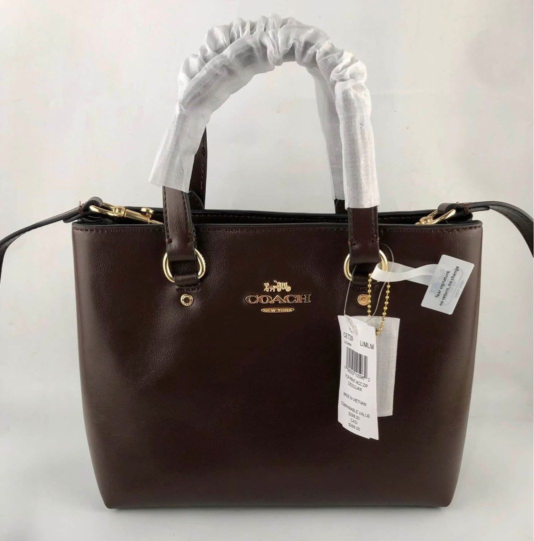 Coach Brown Leather Top Handle Bag (Category: Shoulder Bags) located in Caloocan City. Submitted by brandeditemsph (Listing ID 1451528273, Image 3). Description: - Genuine brown leather Coach bag - Versatile: Top handles and detachable crossbody strap - Elegant gold hardware details - Practical interior zip pocket - Comes with original tags - Proudly made in Vietnam.