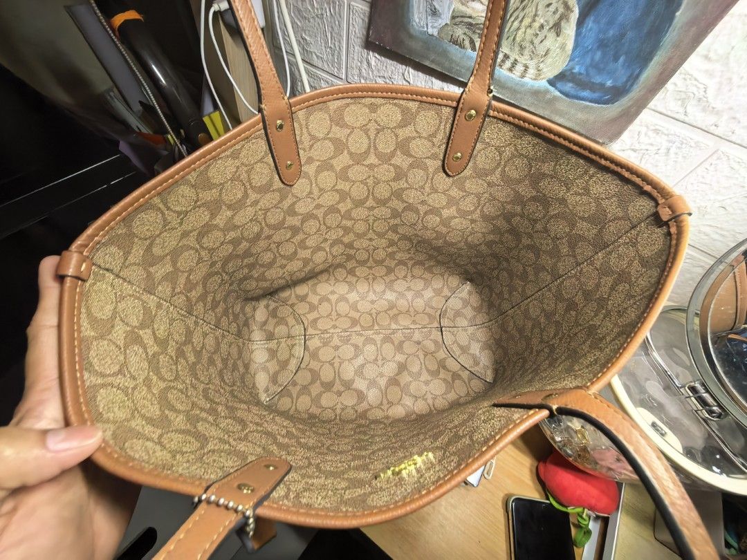 Coach Brown Monogram Reversible Tote Bag (Category: Luxury Bags & Wallets) located in Manila. Submitted by khasseyfinds (Listing ID 1451633781, Image 2). Description: - Classic Coach tote bag - Color: Brown - Signature monogram print inside - Leather trim and handles - Spacious interior, ideal for everyday use - Tag attached - Condition: Good, with minor signs of use only no flaws .
