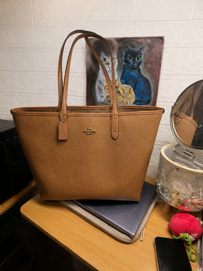 Coach Brown Monogram Reversible Tote Bag (Category: Luxury Bags & Wallets) located in Manila. Submitted by khasseyfinds (Listing ID 1451633781, Image 1). Description: - Classic Coach tote bag - Color: Brown - Signature monogram print inside - Leather trim and handles - Spacious interior, ideal for everyday use - Tag attached - Condition: Good, with minor signs of use only no flaws .