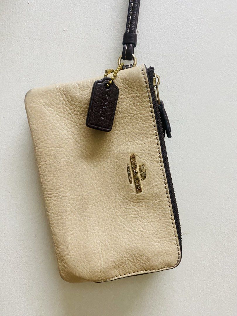 Coach Leather Wristlet Beige Brown Double Zip (Category: Luxury Bags & Wallets) located in Manila. Submitted by TindahanNiLhelay (Listing ID 1451641630, Image 1). Description: - Coach wristlet in beige and brown textured leather. - Two zippered compartments for secure storage. - Includes a dark brown leather hang tag. - Detachable wrist strap for convenience. - Made in Myanmar. - Serial number: N°H2223 91622..
