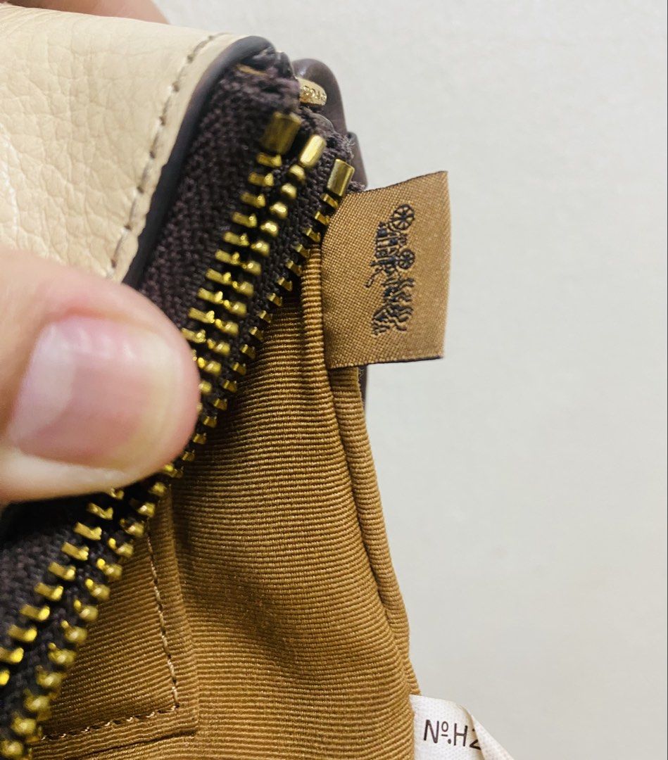 Coach Leather Wristlet Beige Brown Double Zip (Category: Luxury Bags & Wallets) located in Manila. Submitted by TindahanNiLhelay (Listing ID 1451641630, Image 3). Description: - Coach wristlet in beige and brown textured leather. - Two zippered compartments for secure storage. - Includes a dark brown leather hang tag. - Detachable wrist strap for convenience. - Made in Myanmar. - Serial number: N°H2223 91622..