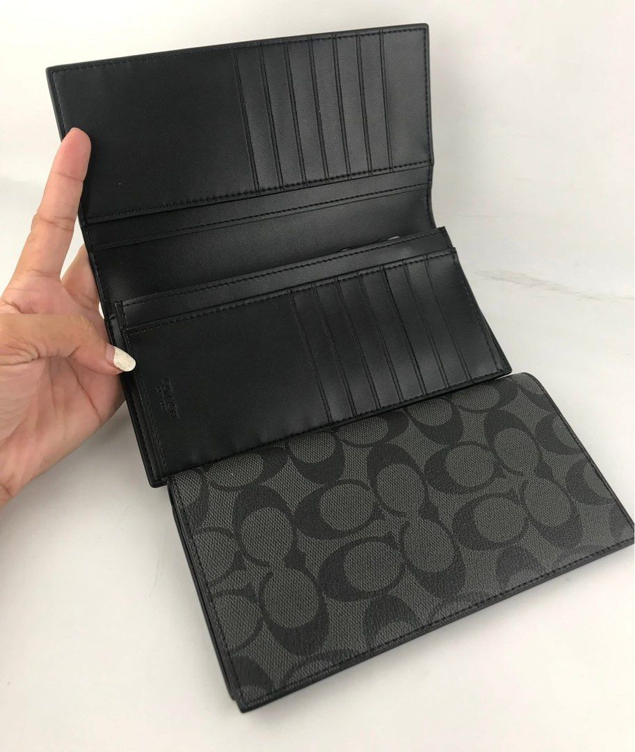 Coach Signature Long Wallet (Category: Wallets & Card holders) located in Caloocan City. Submitted by brandeditemsph (Listing ID 1451527597, Image 1). Description: - Coach long wallet - Signature print in black and grey - Ample card slots for organization - Zippered compartment for coins or small items - Clean interior - Ideal for keeping your essentials tidy.