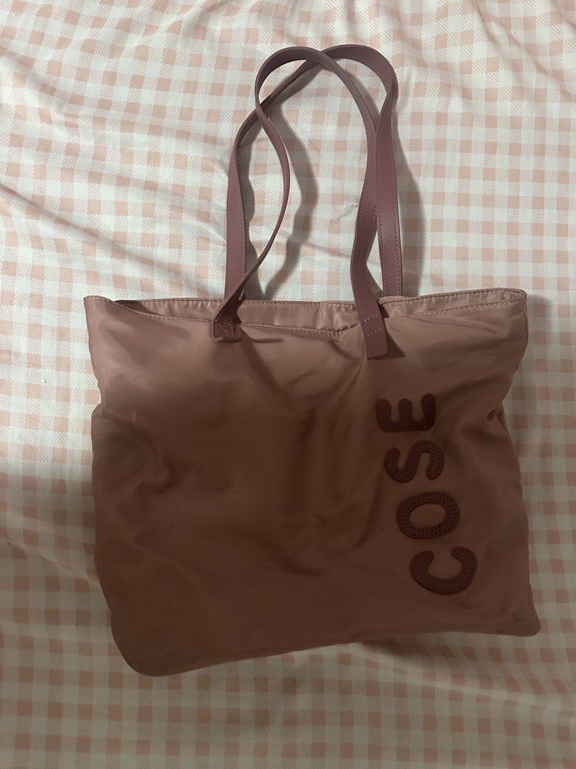 COSE Tote Bag Dusty Rose Nylon (Category: Tote Bags) located in Bacoor. Submitted by ayayesha (Listing ID 1451646184, Image 1). Description: - Dusty rose COSE tote bag - Features a zipped back pocket - Interior has grey lining and a zipped compartment - Spacious for daily essentials - Ideal for work or casual outings.