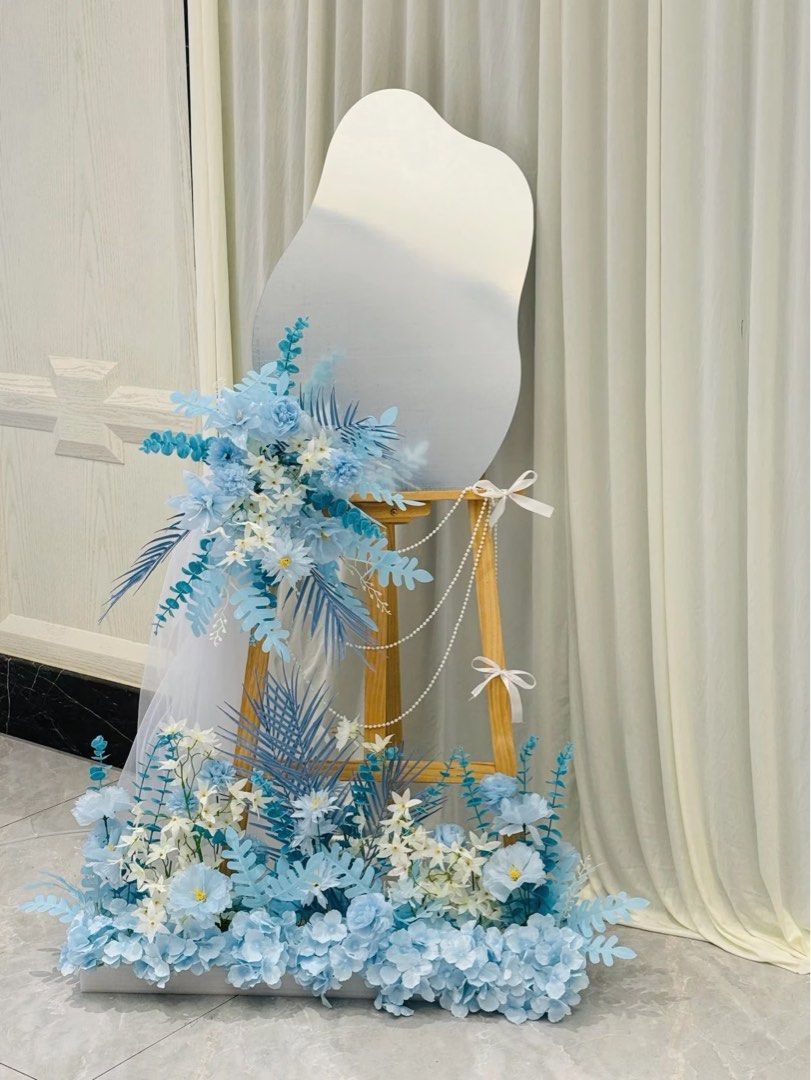 Customizable Cloud Mirror Stand (Category: Mirrors) located in Singapore. Submitted by waddermelon (Listing ID 1451605608, Image 2). Description: - Unique wavy mirror stand - Perfect for wedding, birthdays & parties - Customizable with names and themes - Includes floral decorations as pictured - Ideal for welcoming guests - Easy to set up on an easel - Adds a personal touch to celebrations 70cm by 50cm.