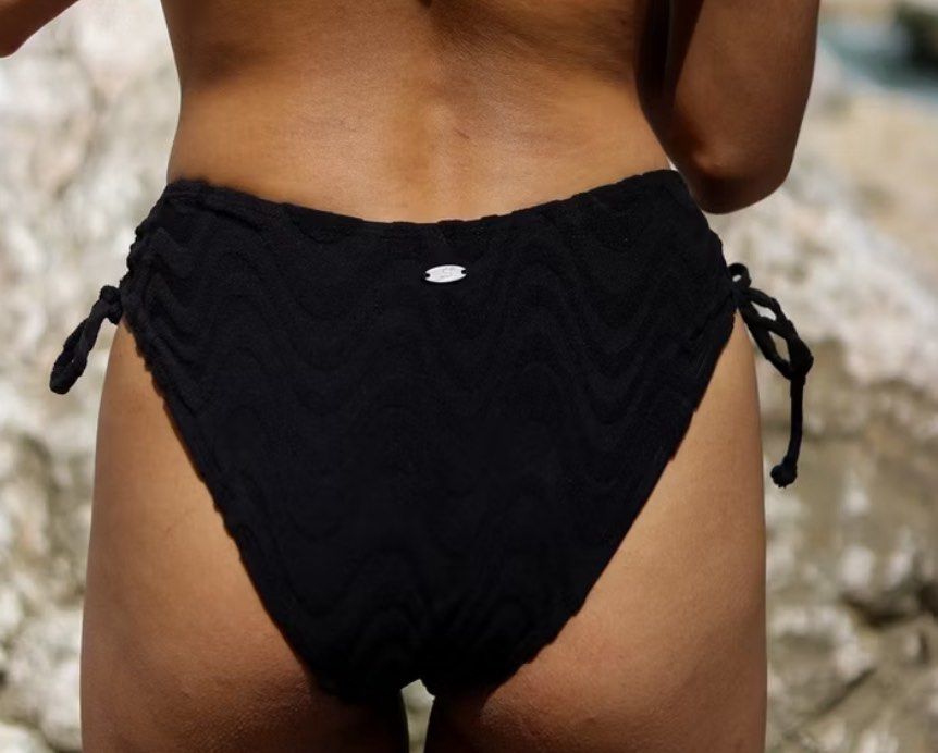 DEAR SEA STORIES - Black Textured Wave Bikini Set (Category: Bikinis & Swimsuits) located in Manila. Submitted by sbm_declutters (Listing ID 1451562312, Image 3). Description: - Chic black bikini set - Unique textured wave pattern - Adjustable tie-side bottoms for a perfect fit - Criss-cross back detail on the top - Comfortable and stylish for beach days or pool parties - Adjustable straps on the top - Moderate coverage bottoms - Removable pads S