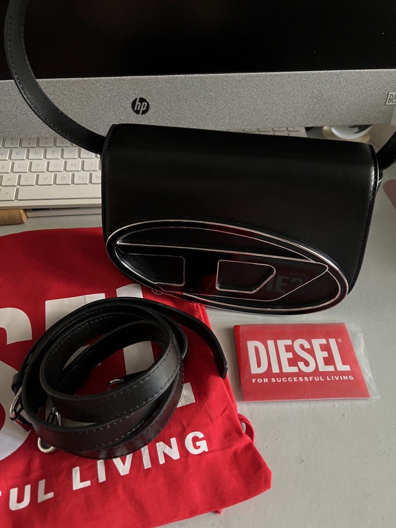Diesel Black Leather Shoulder Bag with D Logo (Category: Luxury Bags & Wallets) located in Makati City. Submitted by heybyemystuff (Listing ID 1451534288, Image 3). Description: - Authentic Diesel black leather shoulder bag - Features iconic silver D logo hardware - Includes a detachable strap for versatility - Comes with original dust bag - Ideal for everyday wear and evening outings - Chic, minimalist design - bought in Germany.
