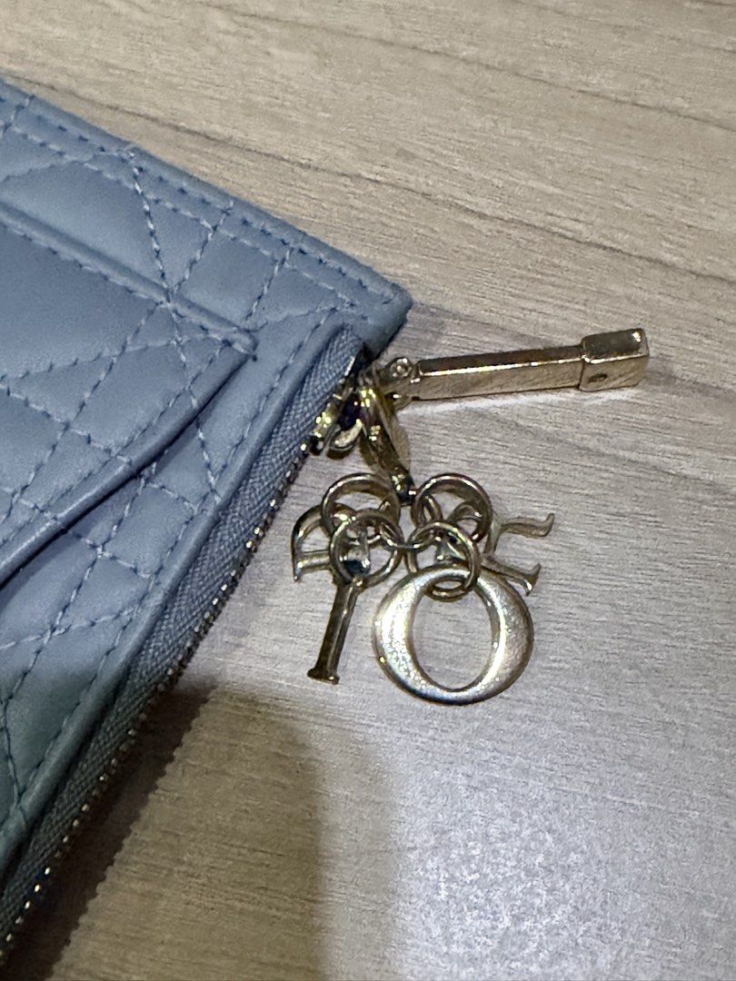 CHRISTIAN DIOR (Auth) Card Holder with Charms (Category: Luxury Bags & Wallets) located in Pasig City. Submitted by theclosetcasemanila (Listing ID 1451622094, Image 3). Description: - Guaranteed Authentic Dior card holder - Elegant quilted pattern on the front - Convenient card slots on the back - Secure zipper closure - Adorned with signature Dior charms on the zipper (detachable) No box or dustbag. Item is unused. .