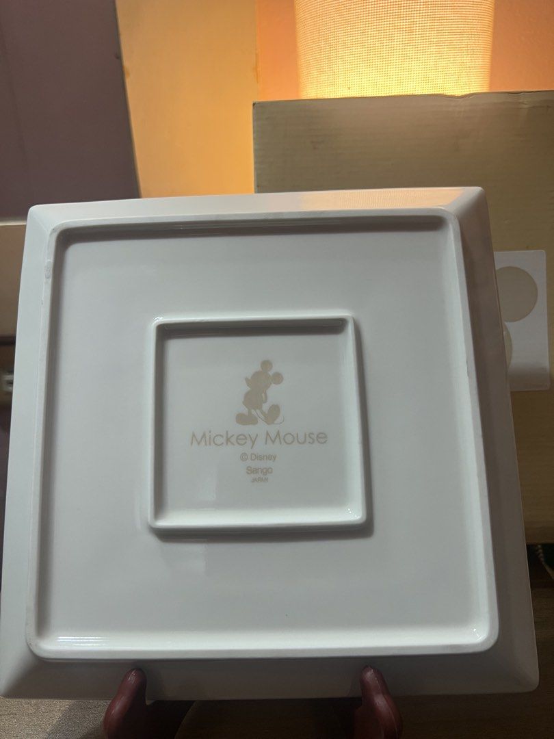 Disney Mickey Mouse Square Serving Platter with Box (Category: Dinnerware & Cutlery) located in Pasig City. Submitted by allaboutstuff.co (Listing ID 1451619388, Image 3). Description: - Square serving platter with subtle Mickey Mouse ear pattern - Made in Japan - Includes original box - Dimensions: Approx. 9 x 9 inches - Ideal for serving snacks or as a decorative piece - A must-have for Disney enthusiasts!.