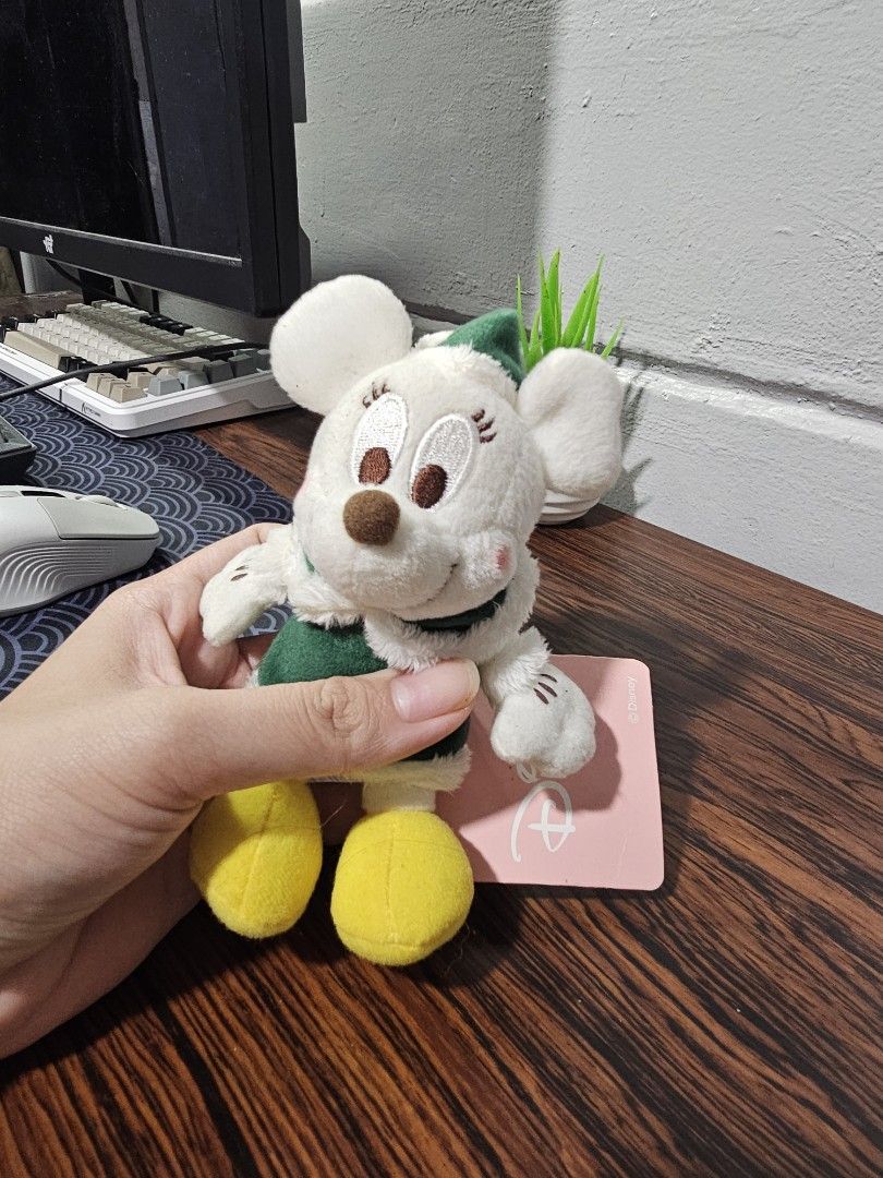 Disney Minnie Mouse Plush Toy with Tag (Category: Plushies & Soft Toys) located in Paranaque City. Submitted by viviperera (Listing ID 1451684339, Image 1). Description: - Adorable Minnie Mouse plush toy - Features a cute green outfit - Green leafy accents on head - White plush with brown and pink details - Comes with original Disney tag - Ideal for Disney enthusiasts and collectors.