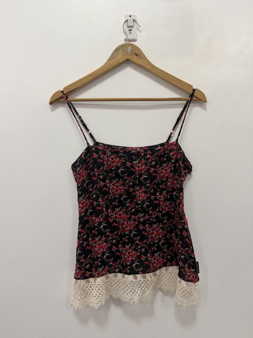 Folded & Hung Floral Cami Top with Lace Trim (Category: Sleeveless) located in Taguig. Submitted by chrisern35 (Listing ID 1451584591, Image 1). Description: - Black cami top - Features a red floral print - Thin spaghetti straps - Delicate lace trim along the hem - Super cute and flowy design - Perfect for casual wear or dressing up Chest - 43cm Length - 46cm.