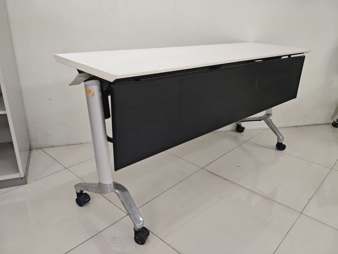 Folding Table with Wheels - White Top, Metal Frame (Category: Tables & Sets) located in Quezon City. Submitted by kevinmacabata12997160 (Listing ID 1451573744, Image 3). Description: - White folding table - Sturdy metal frame - Built-in wheels for easy mobility - Folds flat for convenient storage - Ideal for events, offices, or as an extra workspace - Dimensions: Approx. 150cm x 45cm x70cm - In good, pre-loved condition.