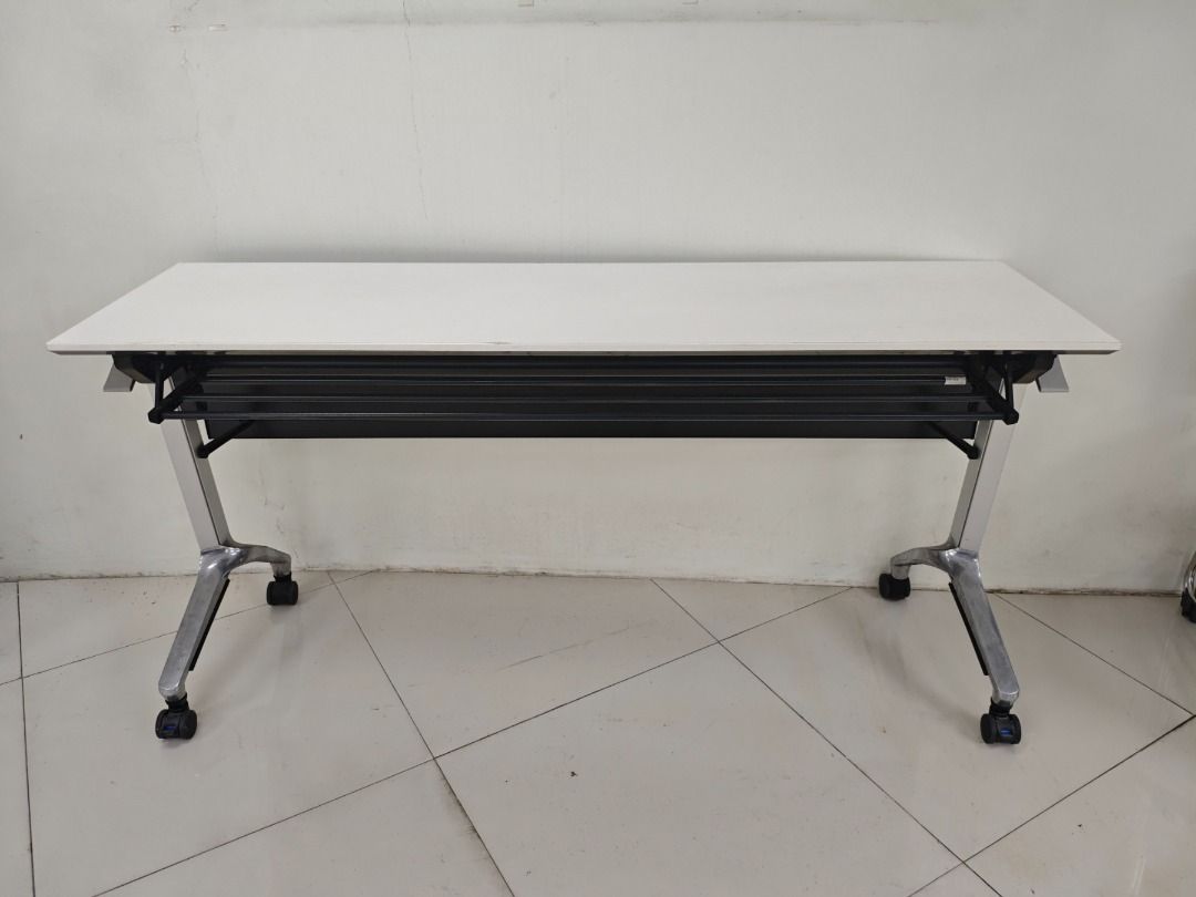 Folding Table with Wheels - White Top, Metal Frame (Category: Tables & Sets) located in Quezon City. Submitted by kevinmacabata12997160 (Listing ID 1451573744, Image 2). Description: - White folding table - Sturdy metal frame - Built-in wheels for easy mobility - Folds flat for convenient storage - Ideal for events, offices, or as an extra workspace - Dimensions: Approx. 150cm x 45cm x70cm - In good, pre-loved condition.