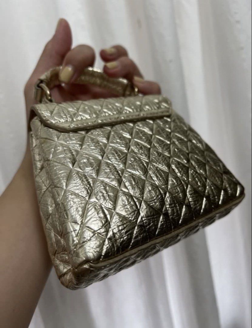 Furla Mini Quilted Metallic Gold Handbag (Category: Luxury Bags & Wallets) located in Taguig. Submitted by cftbncs (Listing ID 1451598886, Image 2). Description: - Super cute mini bag - Metallic gold color with quilted pattern - Turn-lock closure - Comes with a long strap - Ideal for nights out or adding a pop of shine - Small and compact.