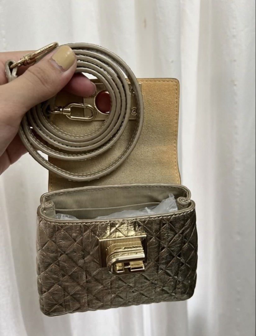 Furla Mini Quilted Metallic Gold Handbag (Category: Luxury Bags & Wallets) located in Taguig. Submitted by cftbncs (Listing ID 1451598886, Image 3). Description: - Super cute mini bag - Metallic gold color with quilted pattern - Turn-lock closure - Comes with a long strap - Ideal for nights out or adding a pop of shine - Small and compact.