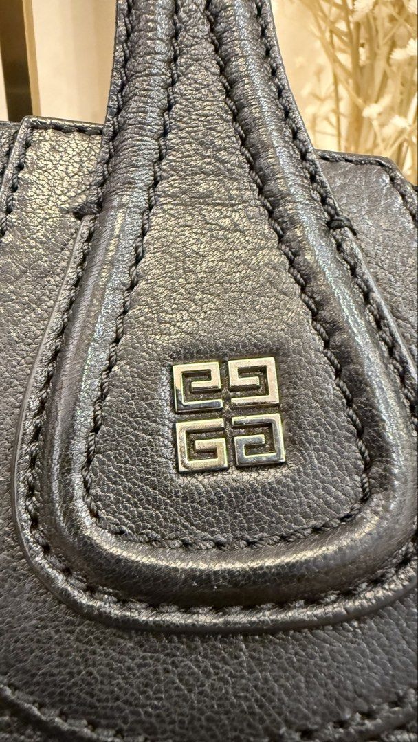 Givenchy Nightingale Bag (Category: Luxury Bags & Wallets) located in Quezon City. Submitted by thirtyfinds (Listing ID 1451589177, Image 3). Description: 💯 Authentic Givenchy Nightingale Bag - Color: Black - Material: Genuine Leather - Iconic design with top handles - Detachable shoulder strap for versatility - Elegant silver hardware details - Interior zip pocket for essentials - "Givenchy Made in Italy" leather label - Zipper pull with Givenc