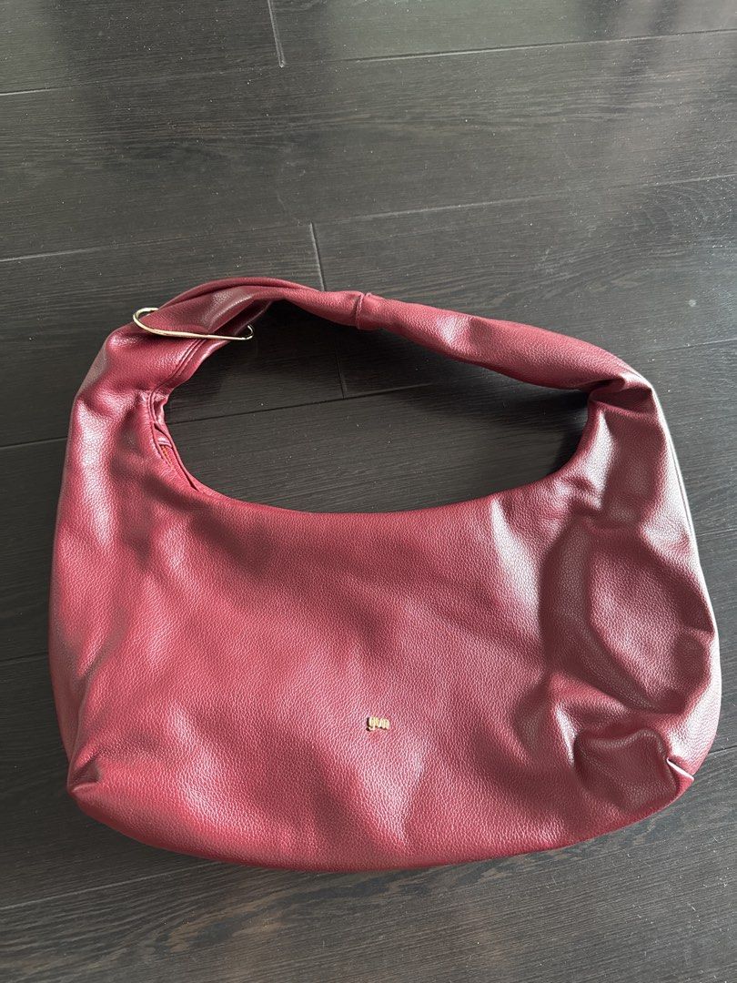 GVN Medium Hobo Bag in Burgundy (Category: Shoulder Bags) located in Marikina City. Submitted by akda7 (Listing ID 1451596519, Image 2). Description: - Burgundy shoulder bag - Faux leather material - Zippered interior pocket - Gold hardware details - Simple and chic design - Ideal for everyday use.
