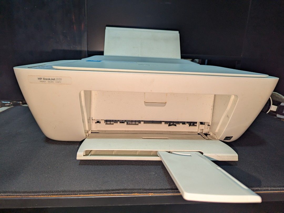 HP DeskJet Printer (Category: Printers, Scanners & Copiers) located in General Trias. Submitted by gia13gia (Listing ID 1451634234, Image 3). Description: - HP DeskJet 2131 All-in-One Printer - Functions: Print, Scan, Copy - Scanner lid opens - Minor scratches on top surface - Negotiable.