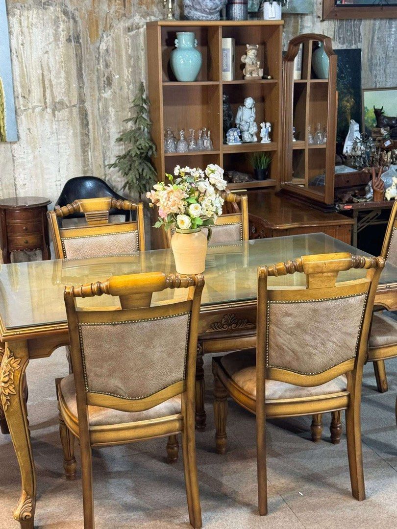 IMPORTED Solid Wood Glass Top Dining Table with 6 Chairs (Category: Tables & Sets) located in Quezon City. Submitted by tinskizarsari (Listing ID 1451619725, Image 2). Description: - Glass-top dining table - Dimensions: 62 inches long x 35 inches wide - Includes 6 chairs with upholstered seats and backs - Warm, golden wood finish - Ideal for family dinners and entertaining - Pickup only.
