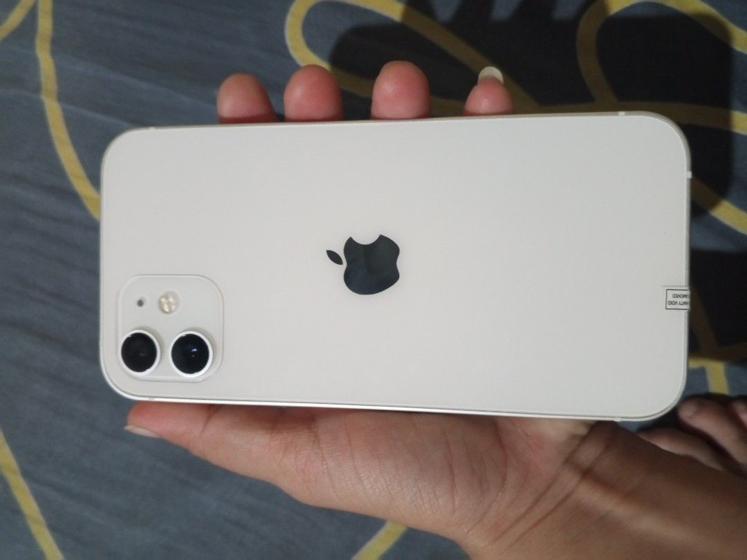iPHONE 12+256GB WHITE (Category: iPhone 12 Series) located in Manila. Submitted by noahskye (Listing ID 1451556363, Image 1). Description: iPHONE 12 256GB WHITE - COMPLETE SET ₱14,000 FIRM Specs: ✓ 256GB Storage - 192GB available pa ✓ Battery Health: 99% - sobrang bago pa ✓ iOS 26.4.1 Updated ✓ Model: MGH33CH/A Openline - all sims ✓ 100% Original, No repair, No issue ✓ Makinis/ No dents Inclusions: - Unit - w/ Box - 20W Apple Charger + Cable - 2 