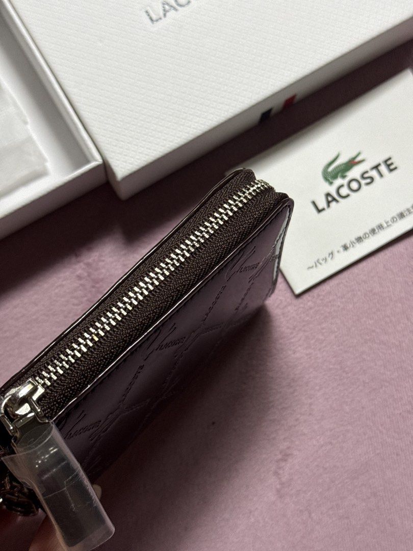 Lacoste Monogram Key Pouch with Box (Category: Luxury Bags & Wallets) located in Pasay City. Submitted by itskshop (Listing ID 1451662141, Image 3). Description: - Authentic Lacoste key pouch - Signature all-over monogram pattern - Dark brown, glossy finish - Secure zipper closure - Interior key hooks and small compartments - Comes with original Lacoste box - Includes authenticity card - Perfect for organizing keys and cards Sobrang ganda please 