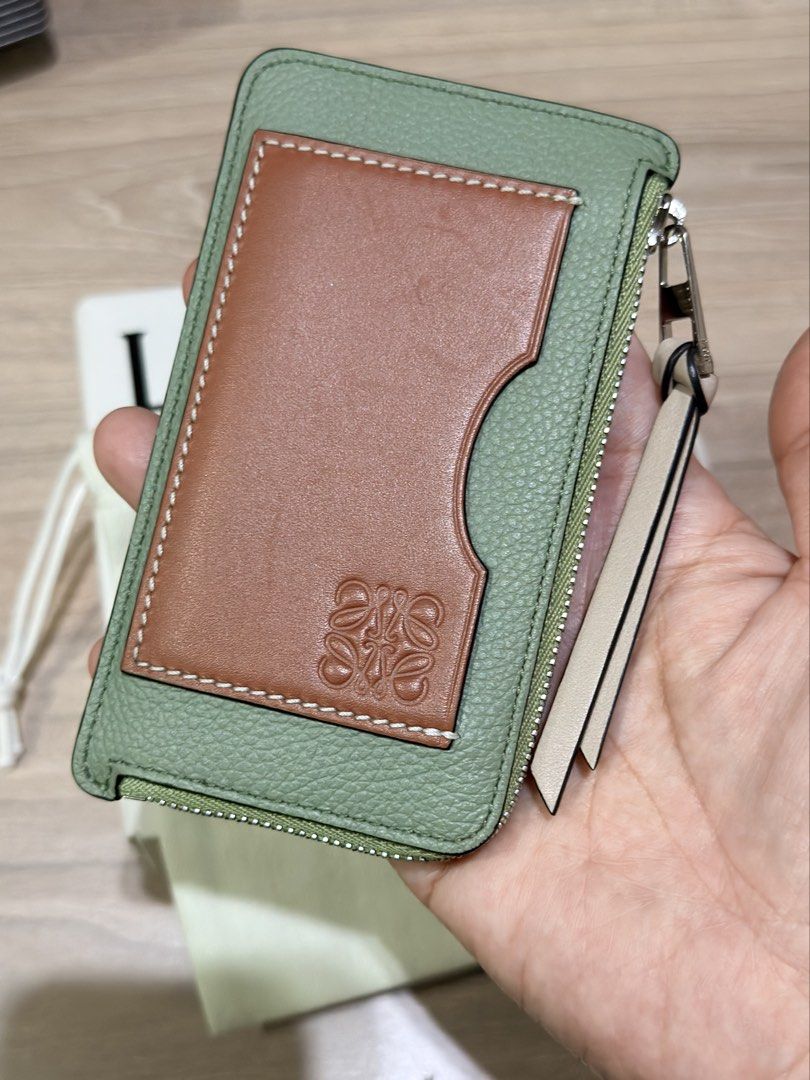 LOEWE (Auth) Cardholder Pouch Mint Green Leather (Category: Luxury Bags & Wallets) located in Pasig City. Submitted by theclosetcasemanila (Listing ID 1451614467, Image 2). Description: - Authentic - Complete box and dustbag - Loewe cardholder w zip pouch - Color: Mint green and tan leather - Closure: Zipper - Features: Multiple card slots on the back - Includes: Dust bag and original box - Benefit: Ideal for keeping your cards organized.